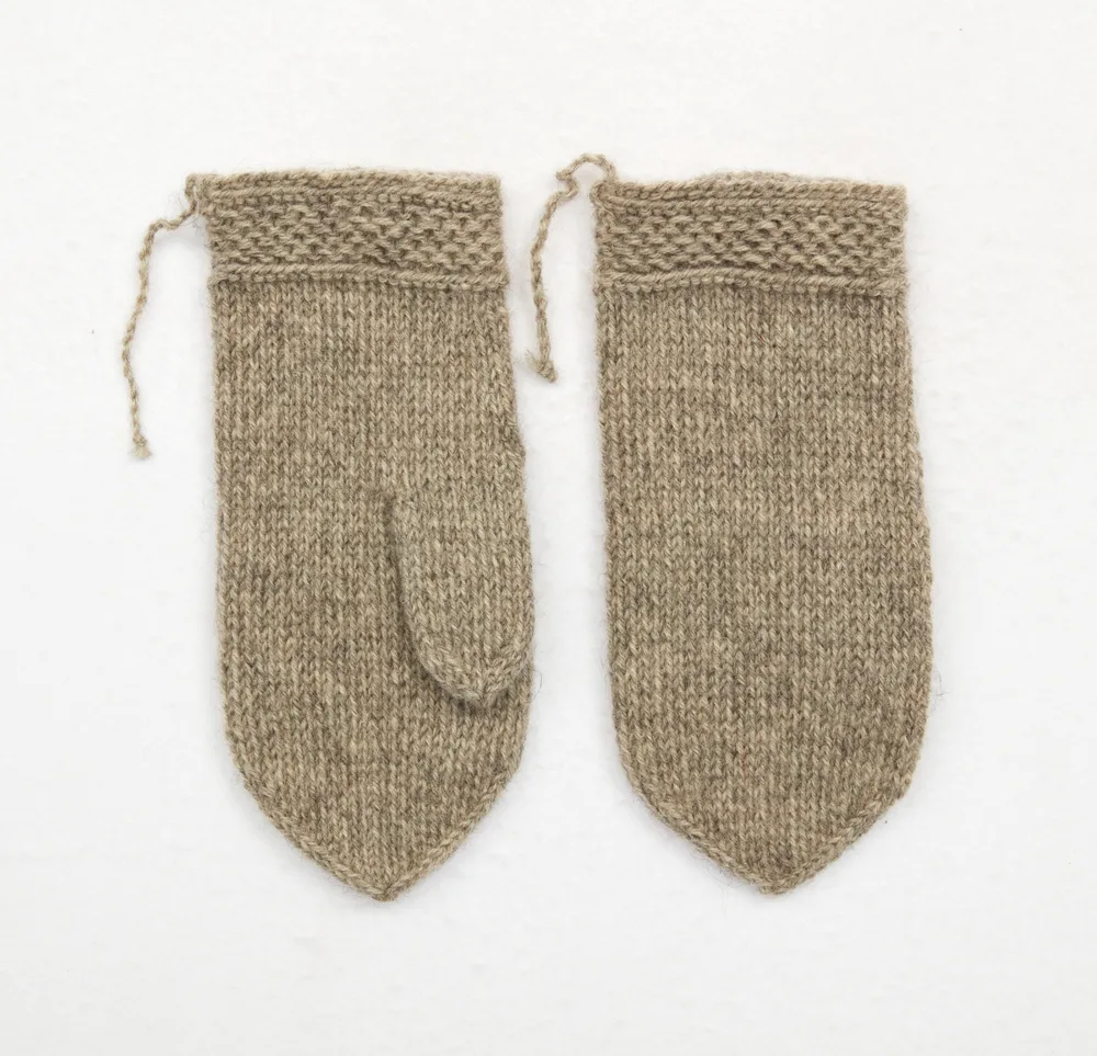 A pair of plain gray knitted mittens with pointed tops, straight thumbs, and a band of purl-stitch texture at the cuff, joined by a twisted cord.